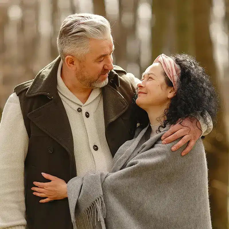 Elderly couple embracing each other with happiness and vitality.