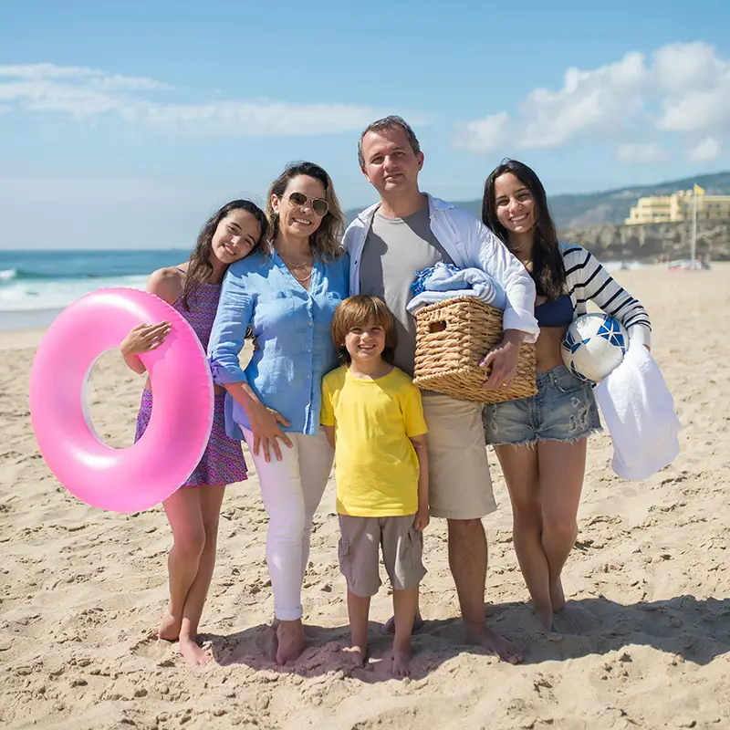 People enjoying a sunny day at the beach, promoting a healthy and active lifestyle.